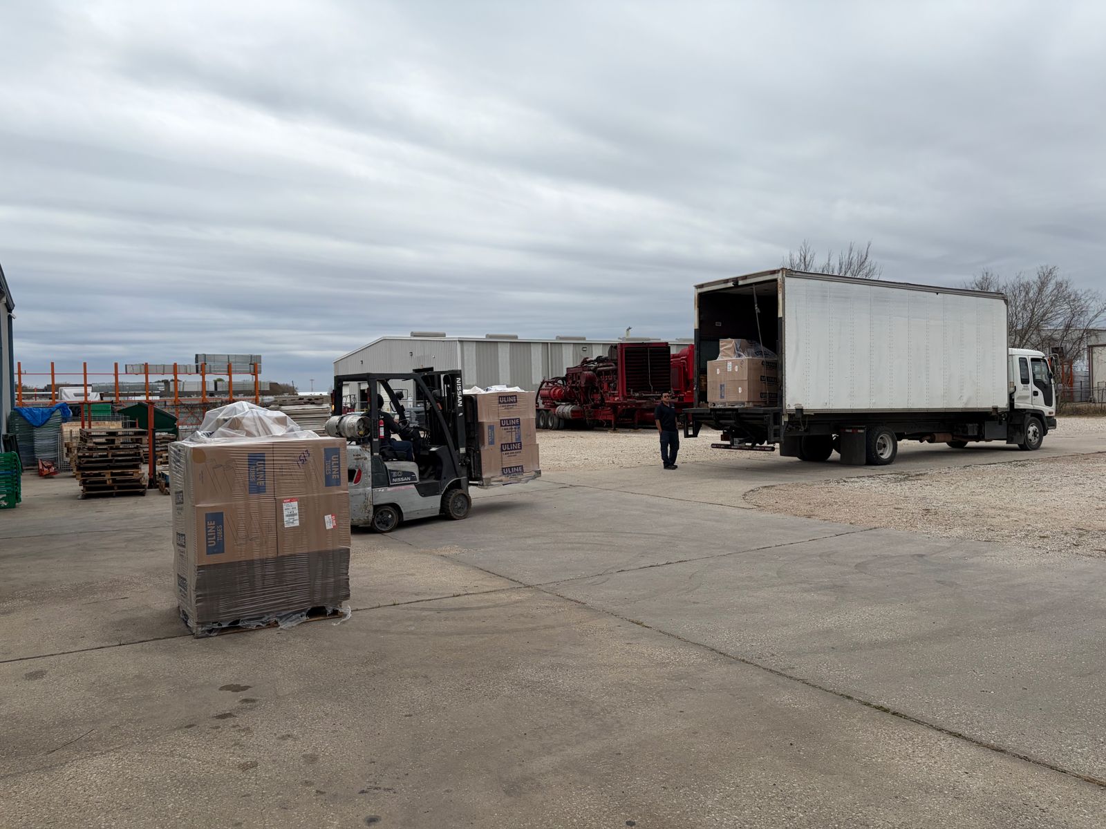 Forklift handling palletized freight during receiving and loadout at FlexPrep
