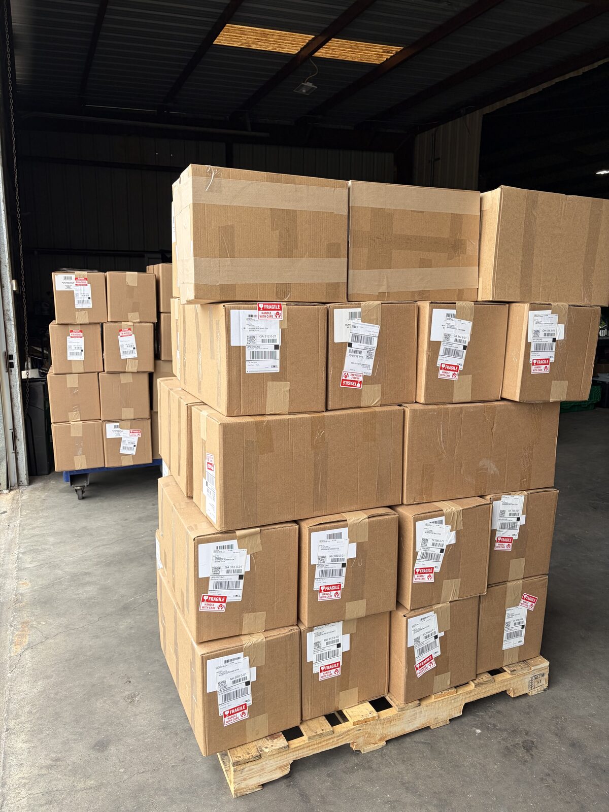 Ground parcels staged and labeled for outbound carrier pickup at FlexPrep