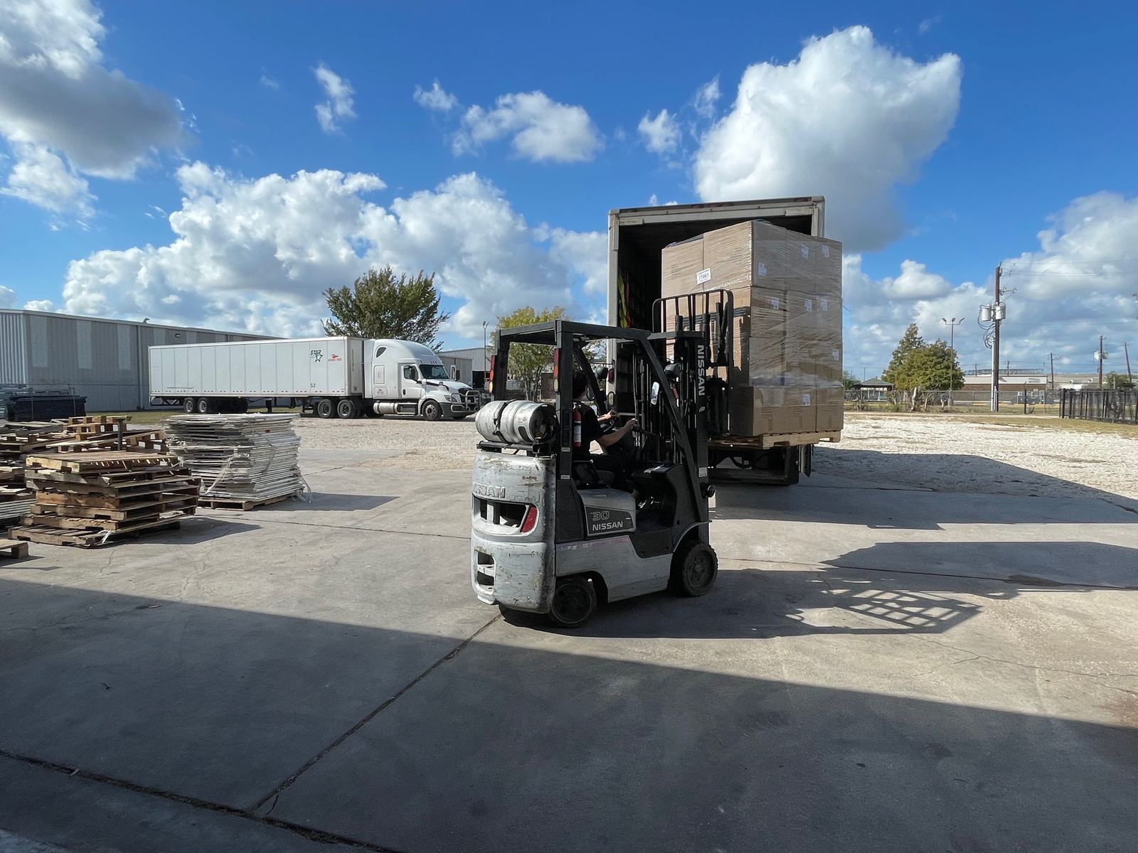 Forklift moving a crated shipment